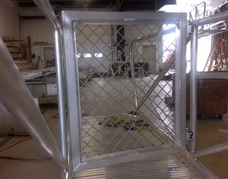 Aluminum gangway to dolphin to which barge is tied.