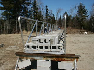 cinderblocks loaded onto aluminum gangway